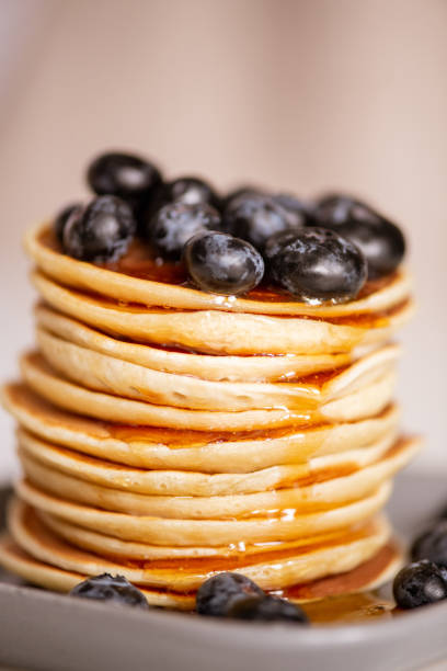 istock Stack of homemade appetizing crepes with fresh honey and blackberries 1250074291
