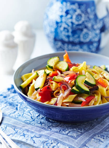 istock Pappardelle Pasta with Vegetables and fresh Basil on bright wooden Background. 1250077162