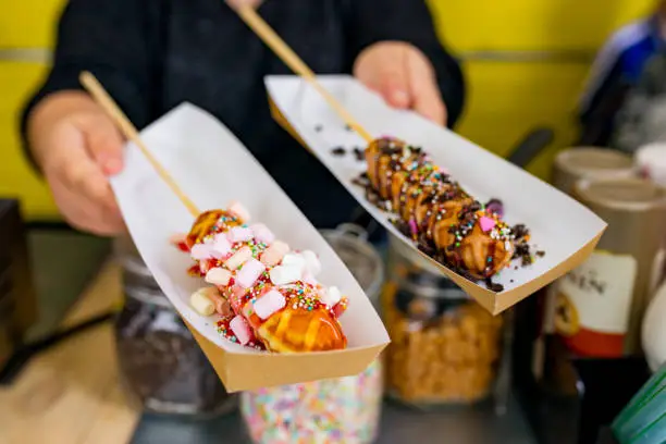 Waffle on a stick with toppings ready to be served at a foodtruck