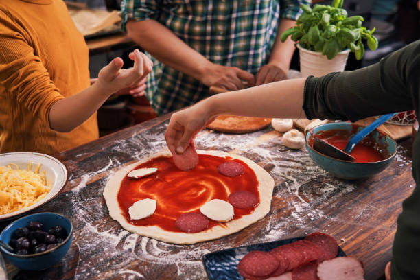 istock Kids Baking with their Mother Pizza at Home 1250077500