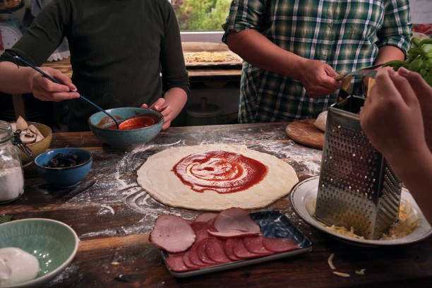 istock Kids Baking with their Mother Pizza at Home 1250078106