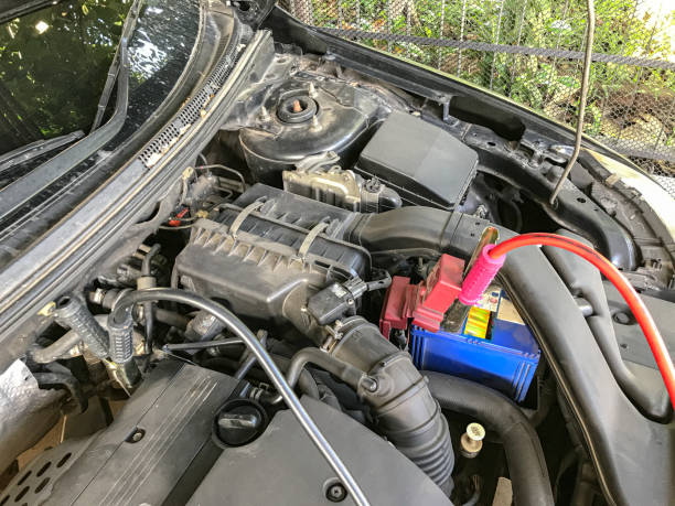 istock Dead car battery jumping. Car assistance by battery jumping 1250078238
