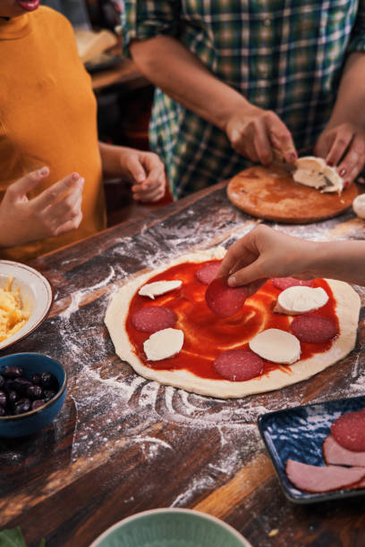 istock Kids Baking with their Mother Pizza at Home 1250078347