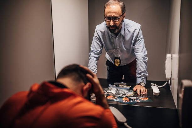 istock Mature detective and prisoner in prison visiting room 1250078749