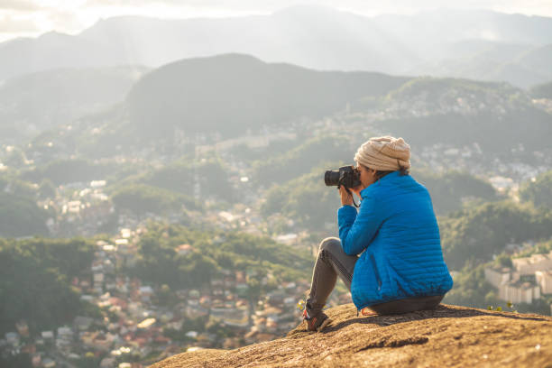 istock Woman photographing landscape 1250081321