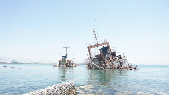 rusty shipwreck in the sea in the harbor
