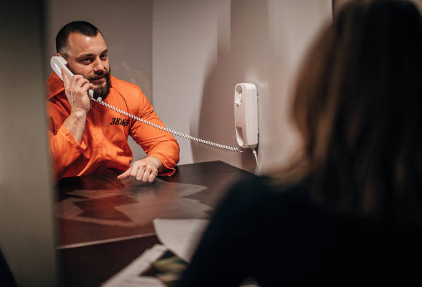 istock Female detective and prisoner sitting in prison visiting room 1250082193