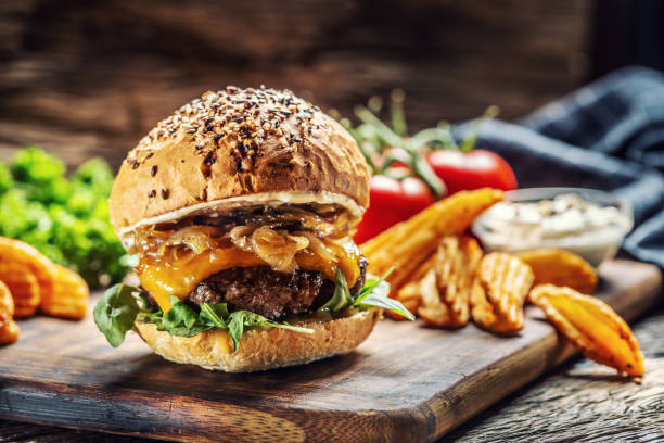 istock Hamburger with caramelized onion, arugula and melted cheese 1250086488
