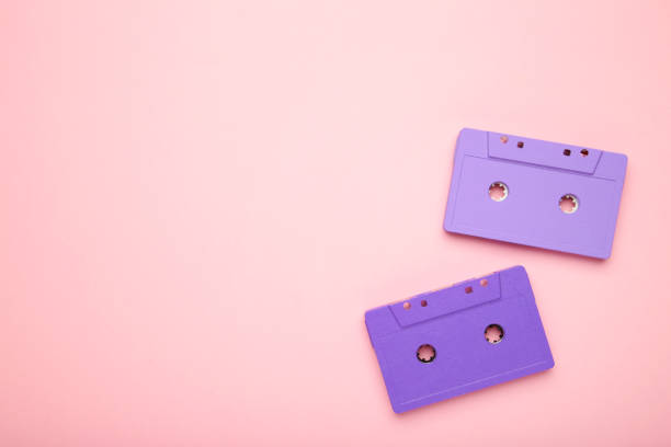 istock Two old colorful cassettes on a pink background. Music day 1250086580