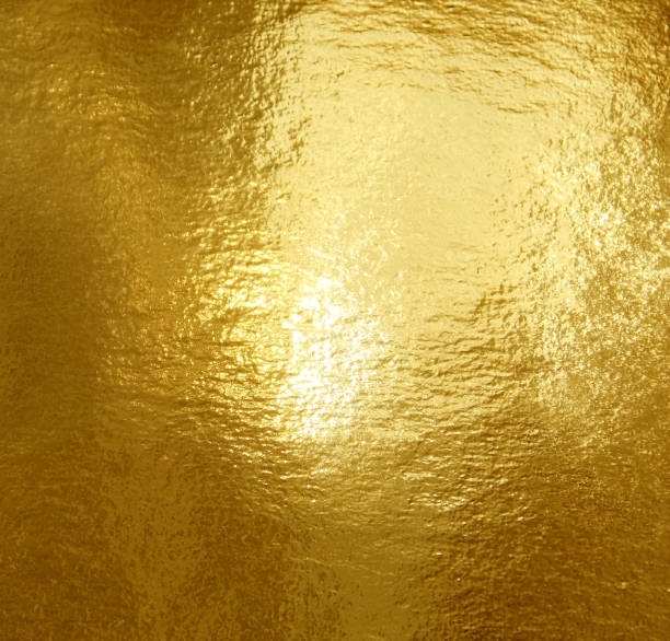 istock Gold foil texture background with highlights and uneven surface 1250087799