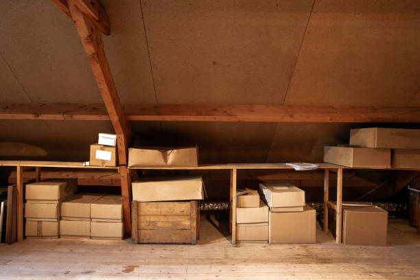 Old wooden attic interior with old cardboard boxes for storage or moving, Old wooden attic interior with old cardboard boxes for storage or moving, close-up attic stock pictures, royalty-free photos & images