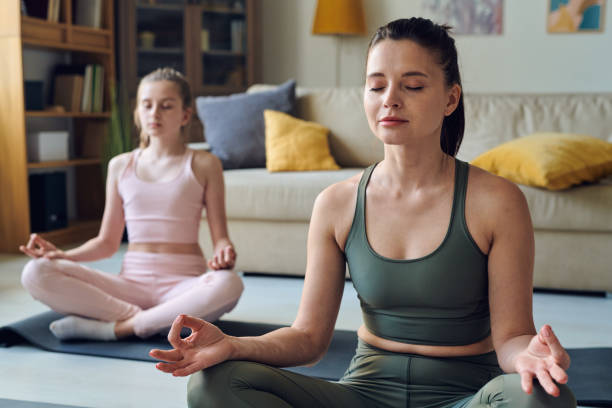 istock Meditating with daughter at home 1250088474