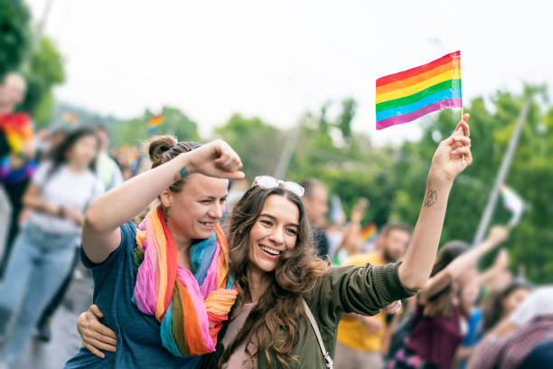 istock Beautiful female couple hugging while marching on the street 1250088657