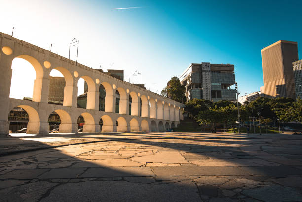 Famous Lapa Arch in Rio de Janeiro Beautiful View of Sun Shining Through Landmark Lapa Arch in Rio de Janeiro City Downtown. rio de janeiro stock pictures, royalty-free photos & images