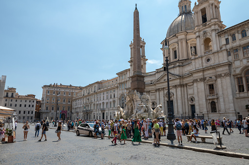 Naples, Italy - December, 18, 2022: Bustling Piazza del Plebiscito, Naples with the iconic San Francesco di Paola Basilica and walking visitors on a sunny day