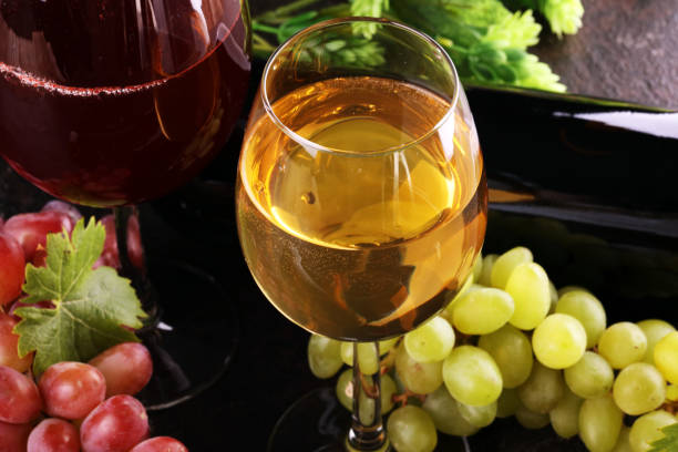 istock red Wine and white wine glass with grapes on rustic background 1250096021