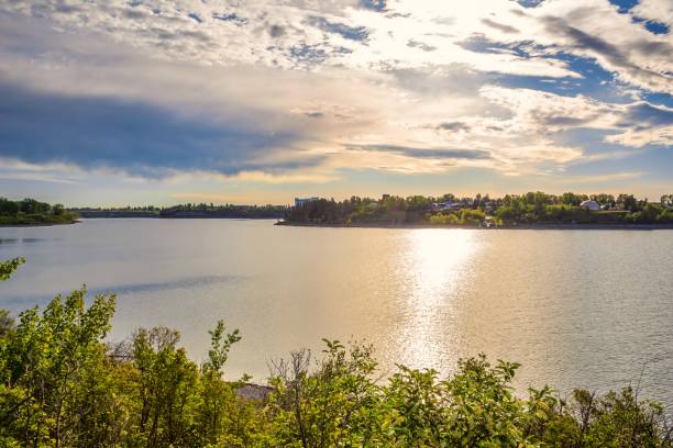 istock Bright Sunshine Clouds Over A City Lake 1250097510