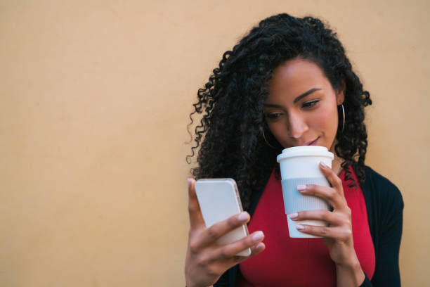 istock Afro woman using her mobile phone. 1250097527