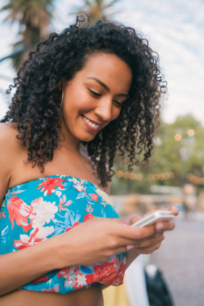 istock Afro American latin woman using mobile phone. 1250097597