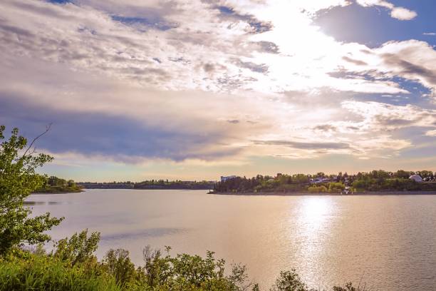 istock Bright Sunshine Clouds Over A City Lake 1250097730