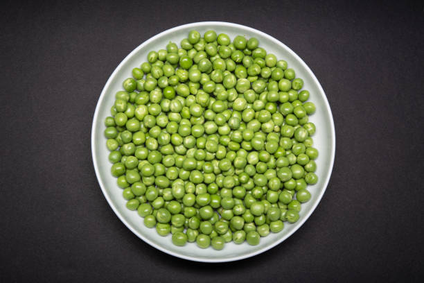 Top view of a plate with fresh Green pea stock photo