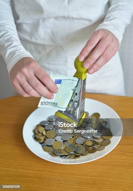 Exchange Euros For Cents Using A Grater Stock Photo - Download Image Now - Banking, Budget, Business