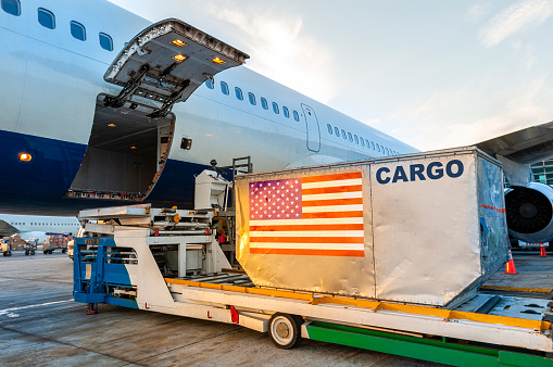 Loading the container with a USA flag in the cargo airplane.