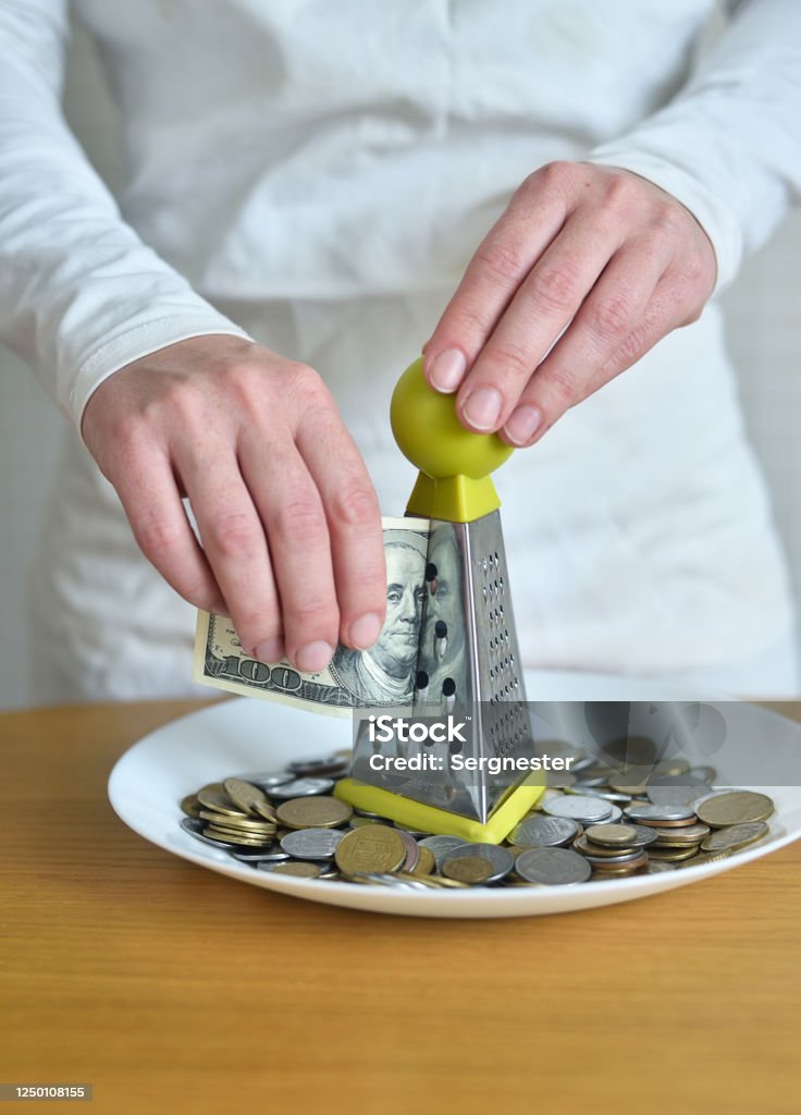 exchange dollars for cents using a grater Banking Stock Photo