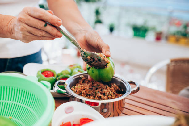 Women preparing grape leaves with rice