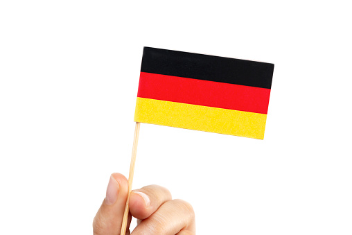 Hand holding Germany flag  wood pole white background