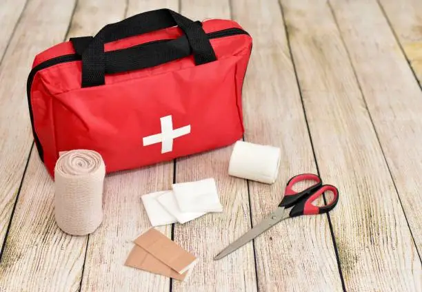 Photo of First aid kit and supplies with simple background for display and example