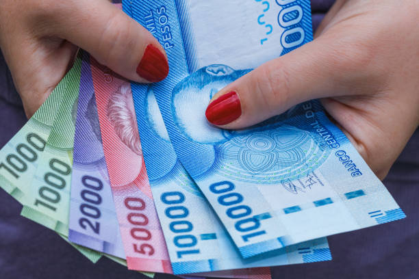 istock Chile money, pesos, banknotes in a woman's hand 1250115871