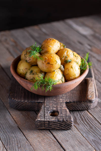 istock Young roasted potatoes with dill in a ceramic bowl 1250117113
