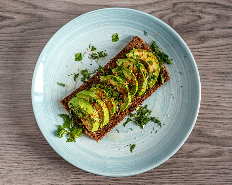 Healthy toast with sliced avocado in Madrid, Community of Madrid, Spain