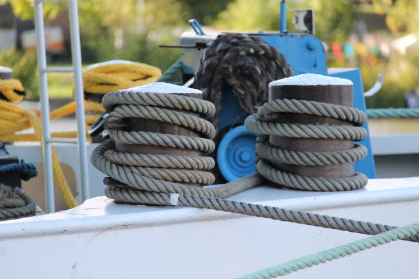Close-up of metal column with yacht secure to piere. Wooden bridge and lake. Boat walk on river. Luxury white water transport. Lesire and spare time outdoors concept