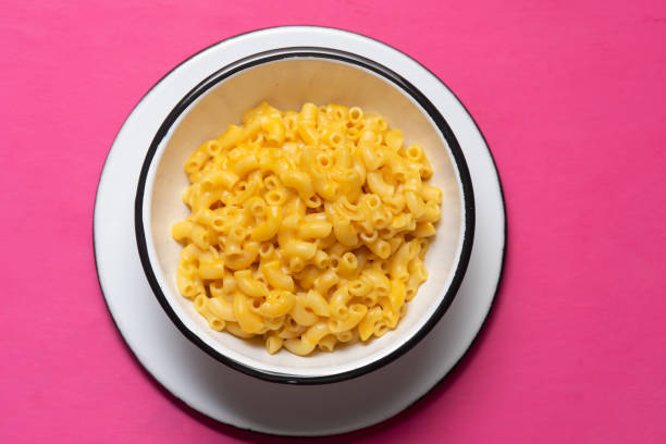 istock Creamy mac and cheese on pink background 1250119244