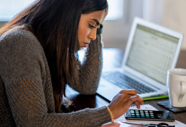 istock Young woman looking at her finances 1250119562