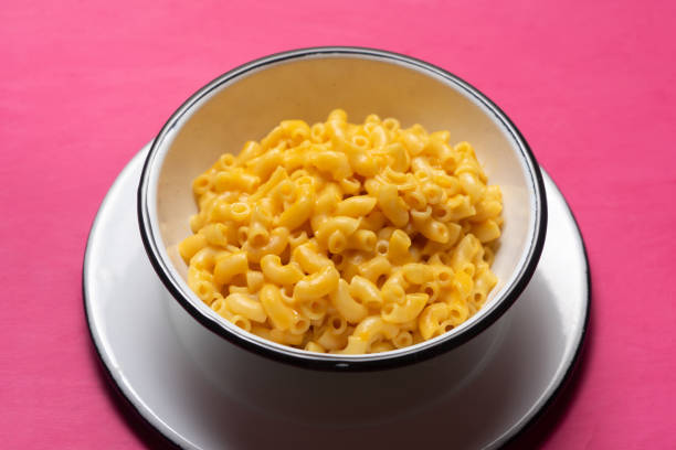 istock Creamy mac and cheese on pink background 1250121497