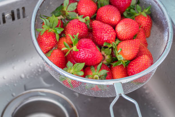 istock Washed strawberries, Fruits in a colander in a sink 1250122112