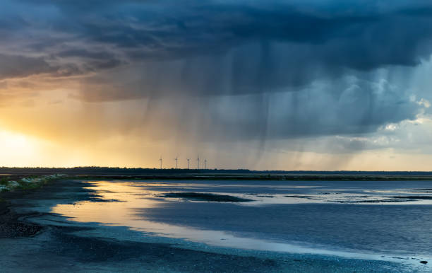 dramatic rain storm over lake at sunset in summer dramatic rain storm over lake at sunset in summer lower saxony photos stock pictures, royalty-free photos & images