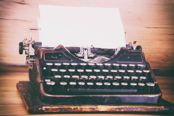 istock Antique Typewriter on rustic wood desk 1250129841