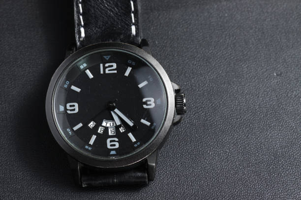 istock A black battery operated watch on black leather background 1250131936
