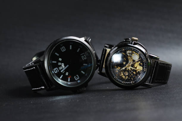 istock a black automatic self winding wristwatch with transparent sekeleton dial design and a black battery operated watch 1250131957