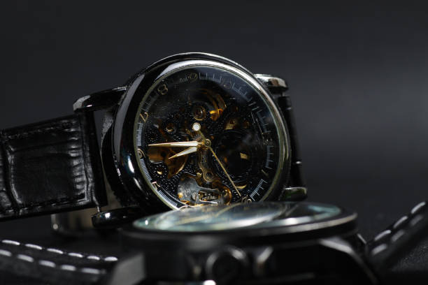 istock a black automatic self winding wristwatch with transparent sekeleton dial design and a black battery operated watch 1250132641