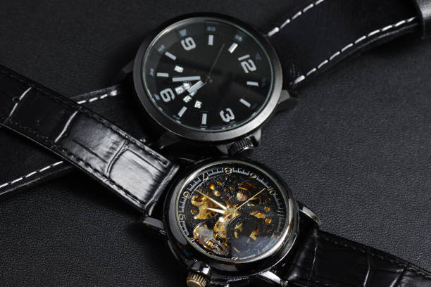 istock a black automatic self winding wristwatch with transparent sekeleton dial design and a black battery operated watch 1250132698