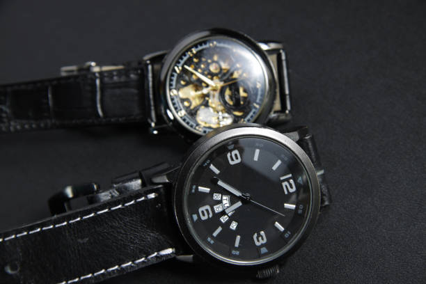 istock a black automatic self winding wristwatch with transparent sekeleton dial design and a black battery operated watch 1250132756