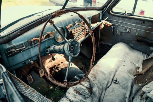 istock Close-up wheel and panel of old vintage rusty abandoned car 1250134597
