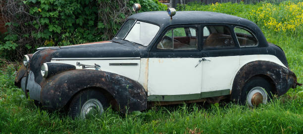 istock Old vintage rusty retro car in green grass 1250135256