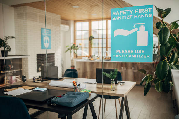 istock Safety first, sanitize hands sign on glass in in empty modern office 1250137065