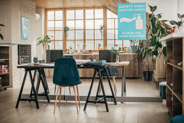 istock Safety first, sanitize hands sign on glass in in empty modern office 1250137072